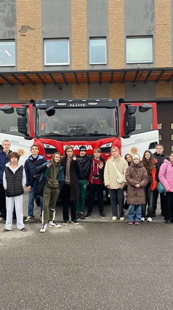 refugee youth infront of a firetruck 